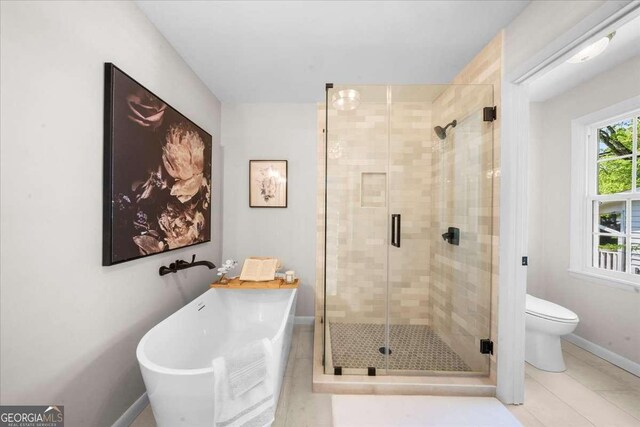 7300 Wynhill Dr, Sandy Springs, GA 30328 - bathroom with a shower stall, a freestanding tub, baseboards, toilet, and tile patterned flooring