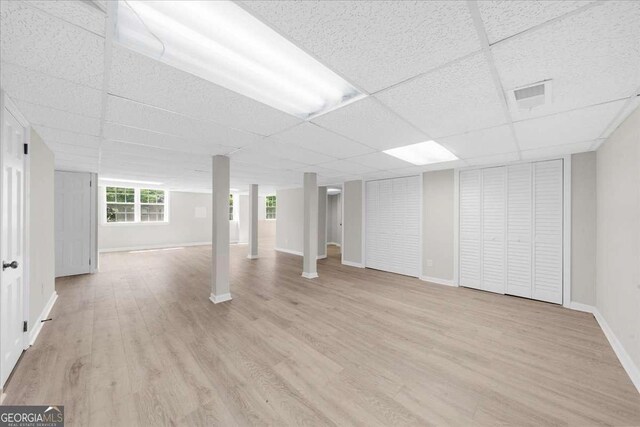 7300 Wynhill Dr, Sandy Springs, GA 30328 - basement featuring light wood-style floors, a paneled ceiling, visible vents, and baseboards