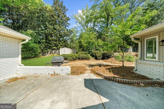7300 Wynhill Dr, Sandy Springs, GA 30328 - view of yard with a patio area, an outbuilding, and a shed
