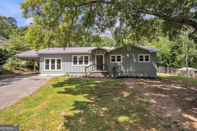 110 Dorsey St, Calhoun, GA 30701 - single story home featuring fence, driveway, a front yard, an attached carport, and board and batten siding