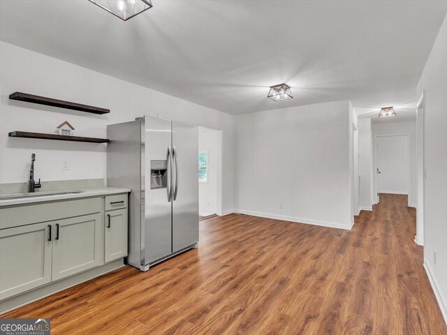 110 Dorsey St, Calhoun, GA 30701 - kitchen featuring open shelves, stainless steel fridge, light wood-type flooring, and a sink