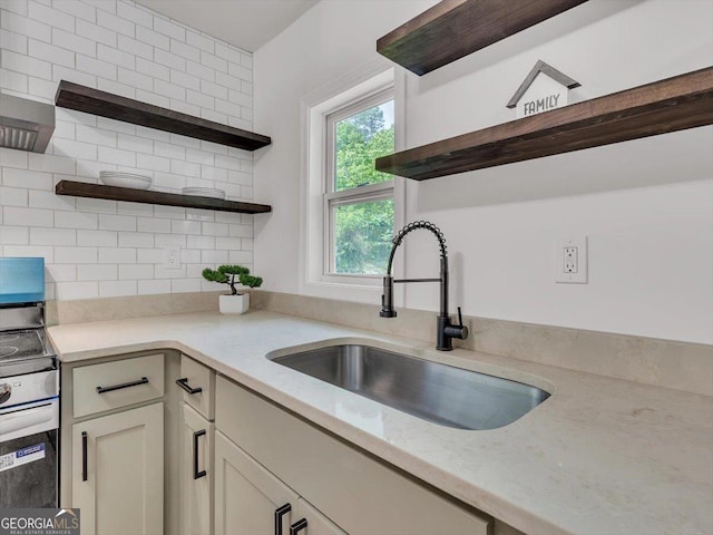 110 Dorsey St, Calhoun, GA 30701 - kitchen with a sink, open shelves, stainless steel electric stove, backsplash, and light stone counters