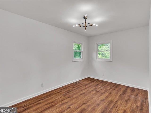 110 Dorsey St, Calhoun, GA 30701 - spare room with an inviting chandelier, baseboards, visible vents, and wood finished floors