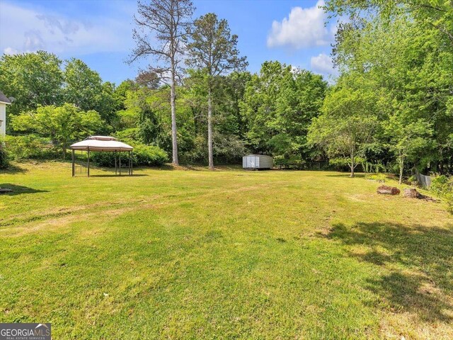 110 Dorsey St, Calhoun, GA 30701 - view of yard featuring an outdoor structure, a gazebo, and a shed