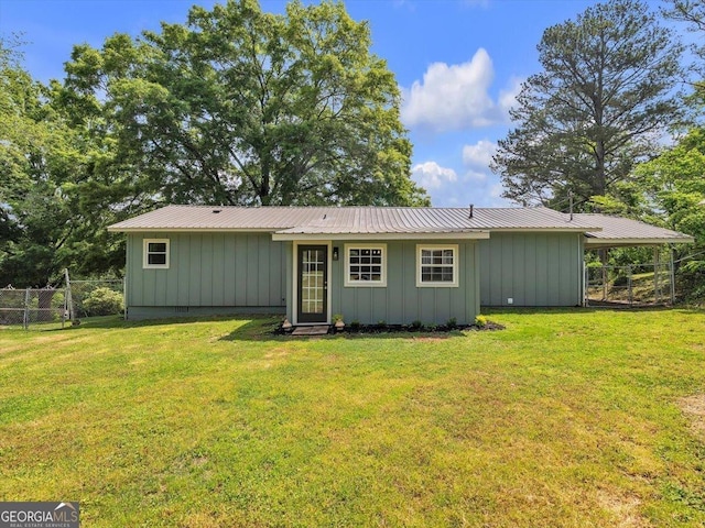 110 Dorsey St, Calhoun, GA 30701 - rear view of house featuring a lawn, fence, and board and batten siding