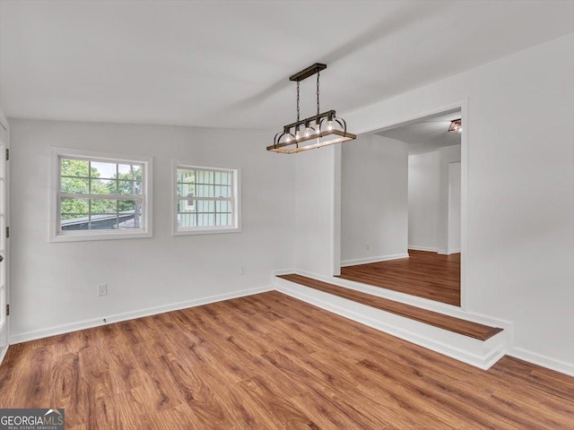 110 Dorsey St, Calhoun, GA 30701 - unfurnished dining area featuring baseboards and wood finished floors
