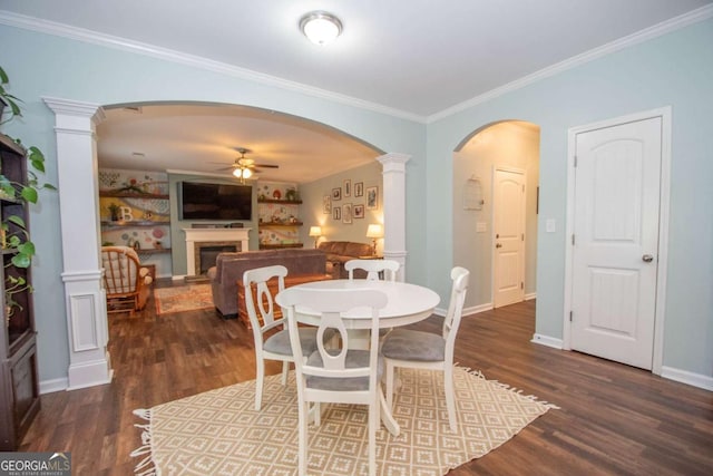 dining space featuring ornate columns, wood finished floors, arched walkways, and ceiling fan