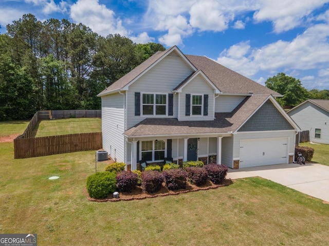 traditional home with driveway, covered porch, an attached garage, fence, and a front yard