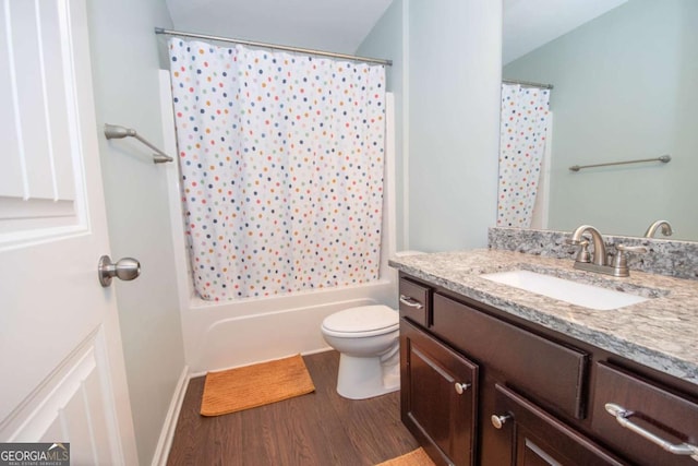 bathroom featuring shower / bath combination with curtain, toilet, vanity, and wood finished floors
