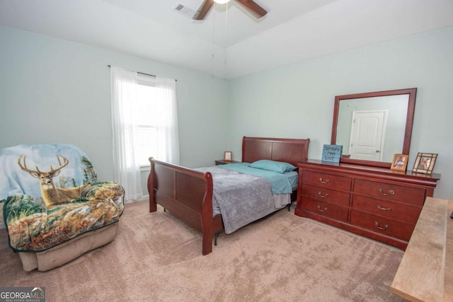 bedroom featuring light carpet, a ceiling fan, and visible vents