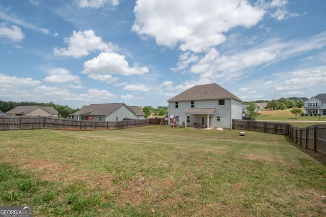 view of yard featuring a fenced backyard and a residential view