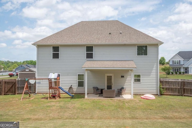 back of property with a fenced backyard, a yard, and a patio