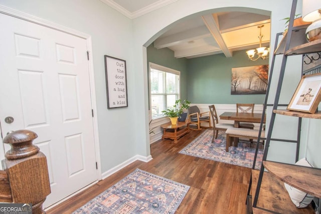 interior space featuring coffered ceiling, wood finished floors, ornamental molding, arched walkways, and beam ceiling