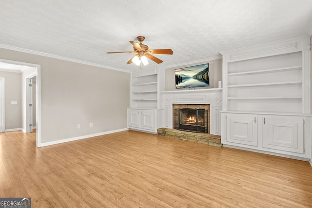 unfurnished living room featuring baseboards, a ceiling fan, built in features, and wood finished floors