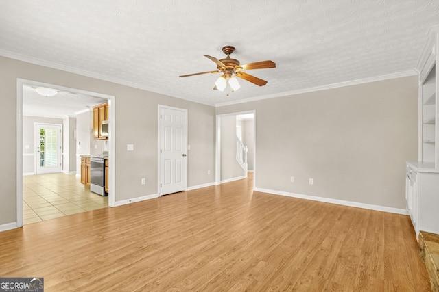 unfurnished living room featuring light wood-style floors, baseboards, crown molding, and a ceiling fan