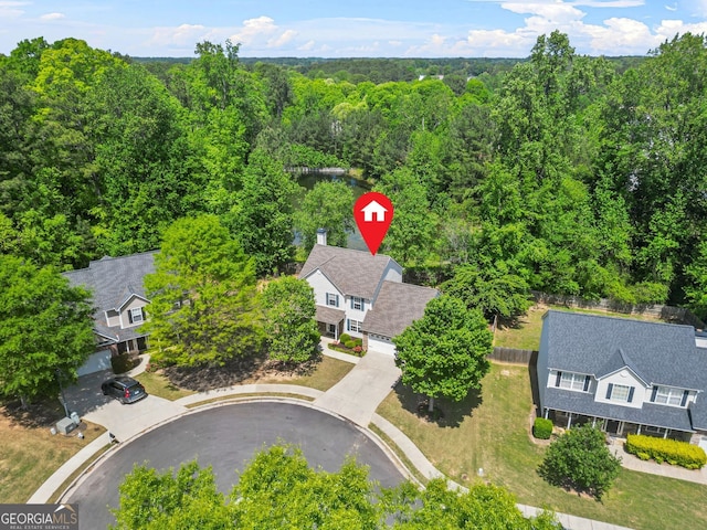 birds eye view of property with a forest view