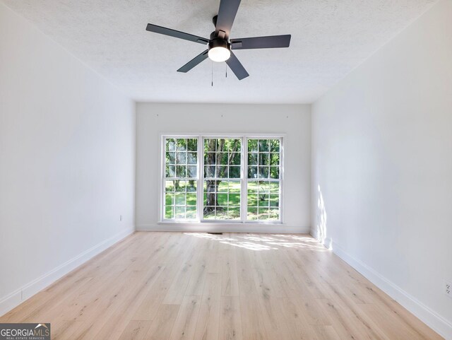 laundry room with hookup for an electric dryer, light wood-type flooring, hookup for a washing machine, and baseboards