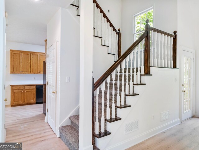 staircase with wood finished floors and baseboards