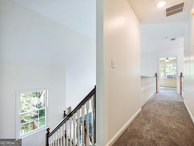 hallway with carpet floors, baseboards, an upstairs landing, and recessed lighting