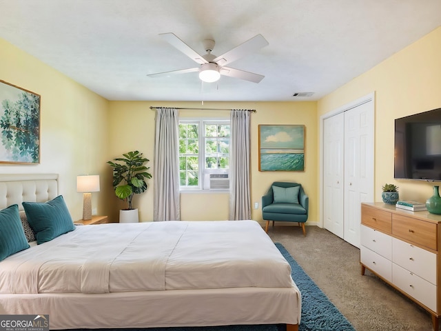 carpeted bedroom with a closet, a ceiling fan, baseboards, and cooling unit