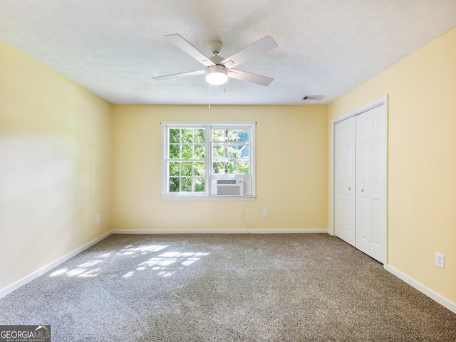 unfurnished bedroom with carpet flooring, baseboards, a closet, and a textured ceiling