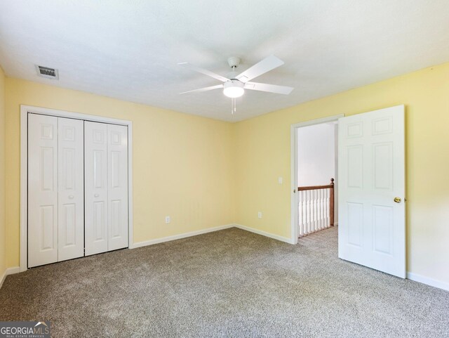 unfurnished bedroom with carpet floors, baseboards, a closet, and a ceiling fan
