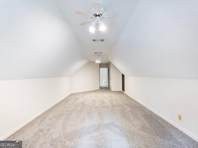 bonus room featuring carpet, vaulted ceiling, baseboards, and a ceiling fan
