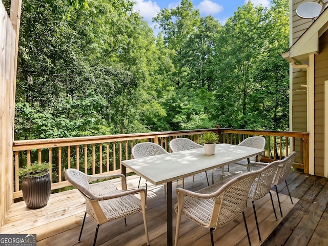 wooden terrace with outdoor dining area