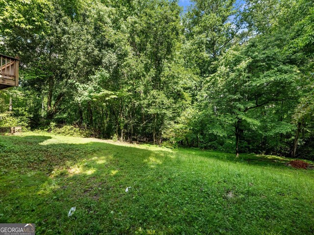 view of yard with a view of trees