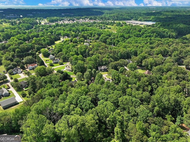 aerial view of property and surrounding area featuring a forest