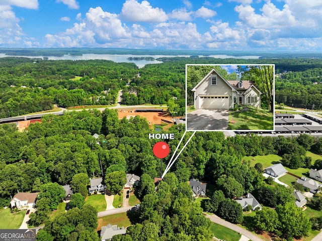 view of property location featuring a heavily wooded area, property boundaries highlighted, and a nearby body of water