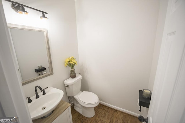 2019 Chelton Way SE, Smyrna, GA 30080 - half bath with toilet, wood finished floors, vanity, and baseboards