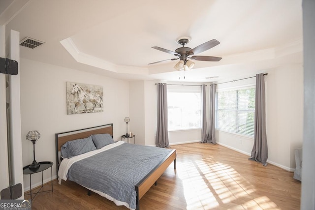2019 Chelton Way SE, Smyrna, GA 30080 - bedroom featuring a raised ceiling, baseboards, light wood-style flooring, a ceiling fan, and ornamental molding