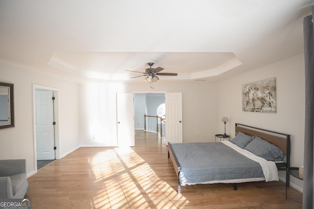 2019 Chelton Way SE, Smyrna, GA 30080 - bedroom featuring a raised ceiling, wood finished floors, baseboards, and ceiling fan