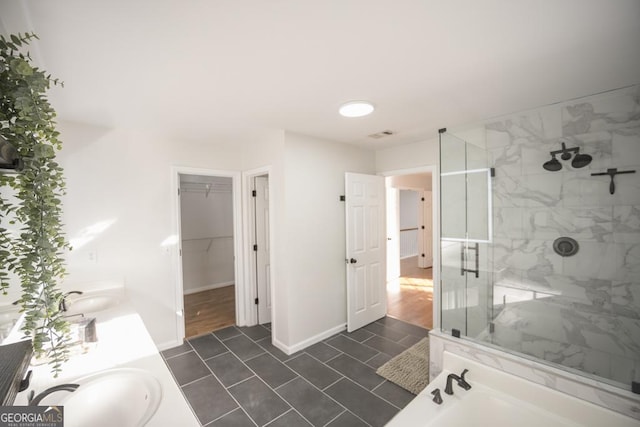 2019 Chelton Way SE, Smyrna, GA 30080 - bathroom featuring a stall shower, a walk in closet, baseboards, tile patterned flooring, and double vanity