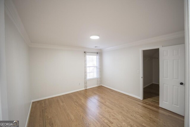 2019 Chelton Way SE, Smyrna, GA 30080 - empty room with ornamental molding, light wood-style flooring, and baseboards