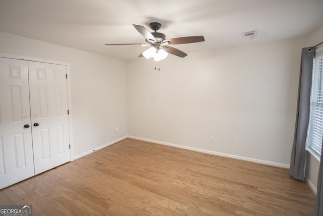 2019 Chelton Way SE, Smyrna, GA 30080 - unfurnished bedroom featuring light wood finished floors, baseboards, a closet, and a ceiling fan
