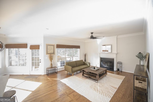 2019 Chelton Way SE, Smyrna, GA 30080 - living area featuring crown molding, ceiling fan, a fireplace, baseboards, and wood finished floors