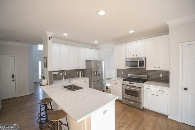 2019 Chelton Way SE, Smyrna, GA 30080 - kitchen with stainless steel appliances, a sink, ornamental molding, a peninsula, and a kitchen breakfast bar