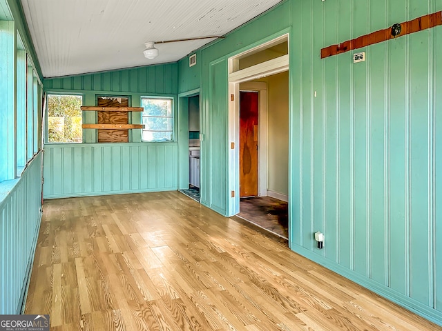 712 E College St, Bainbridge, GA 39819 - empty room with light wood-style floors and vaulted ceiling