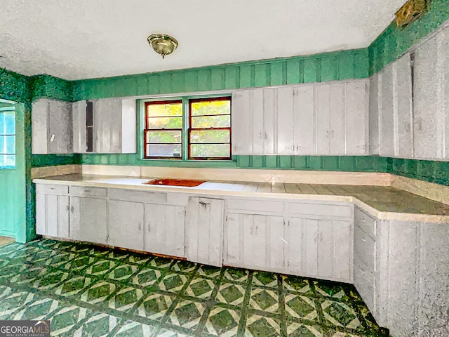 kitchen with white cabinets, tile patterned floors, and light countertops
