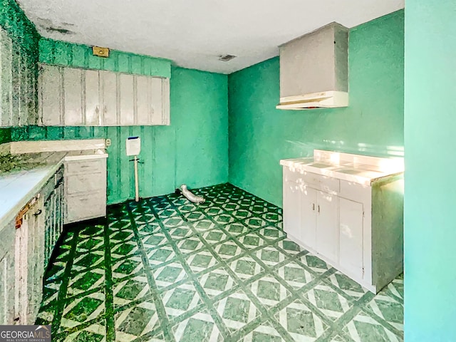 clothes washing area featuring light floors and visible vents