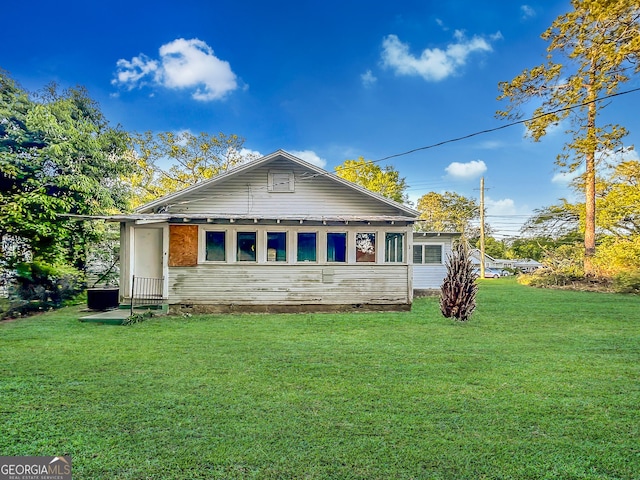 back of property with a lawn
