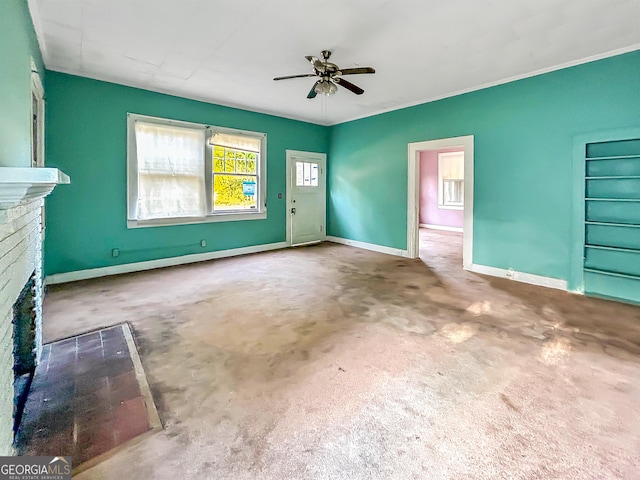 unfurnished living room featuring carpet, baseboards, a ceiling fan, and a fireplace