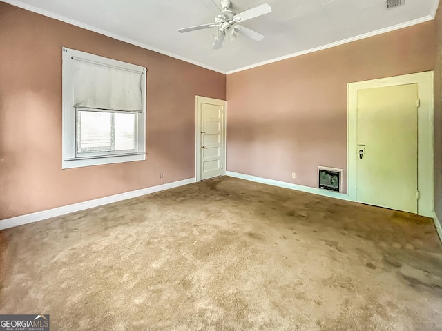 spare room featuring crown molding, baseboards, a ceiling fan, and heating unit
