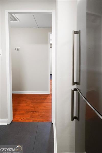 2965 Pharr Ct S Unit 110, Atlanta, GA 30305 - corridor with visible vents, tile patterned flooring, and baseboards