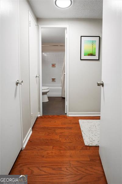 2965 Pharr Ct S Unit 110, Atlanta, GA 30305 - hallway with wood finished floors