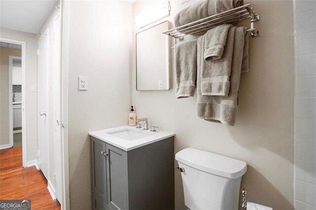 2965 Pharr Ct S Unit 110, Atlanta, GA 30305 - bathroom with toilet, vanity, and wood finished floors