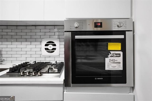 2965 Pharr Ct S Unit 110, Atlanta, GA 30305 - details featuring backsplash, appliances with stainless steel finishes, and light countertops
