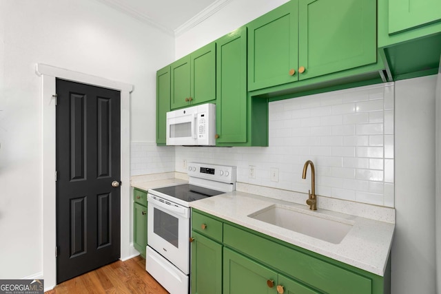 69 Hogue St NE, Atlanta, GA 30312 - kitchen featuring white appliances, green cabinets, a sink, ornamental molding, and tasteful backsplash